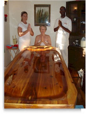 Julia Mader receives her annual Pizhichil treatment program from 2 trainees learning the art of Pizhichil Ayurveda oiling.